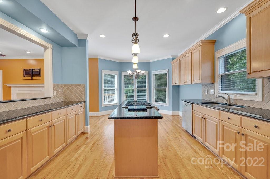 656 Amberly Crossing Fort Mill, SC 29708 - Photo 9 of 44 a large kitchen with granite countertop a large counter top space a sink stainless steel appliances and cabinets