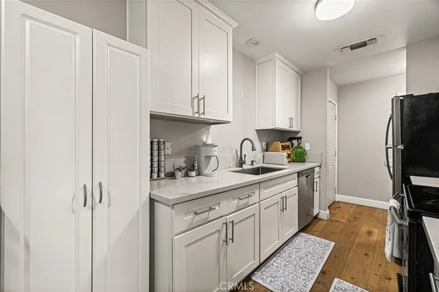 a kitchen with stainless steel appliances granite countertop a refrigerator stove and microwave