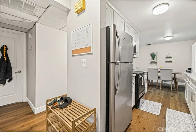 a kitchen with sink a refrigerator and cabinets