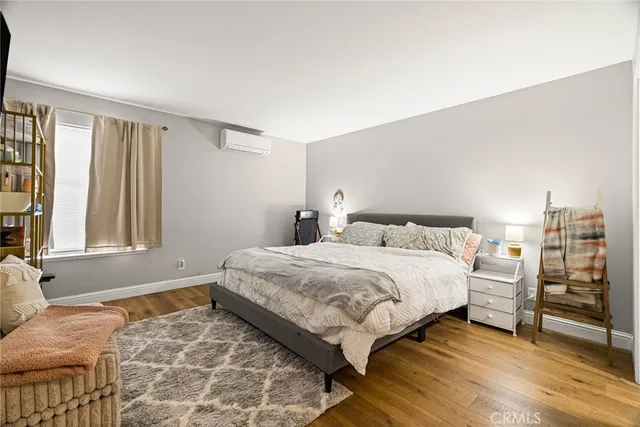 a bedroom with a bed and a dresser in it