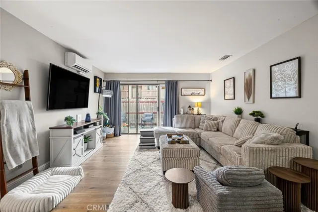 a hotel room with a couch and a flat screen tv