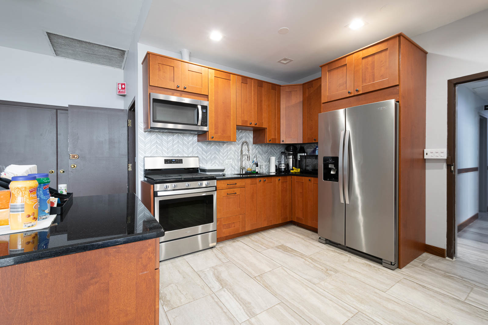 6325 North Sheridan Road, Unit 1508 Chicago, IL 60660 - Photo 10 of 16 a kitchen with stainless steel appliances wooden cabinets a refrigerator and a stove top oven