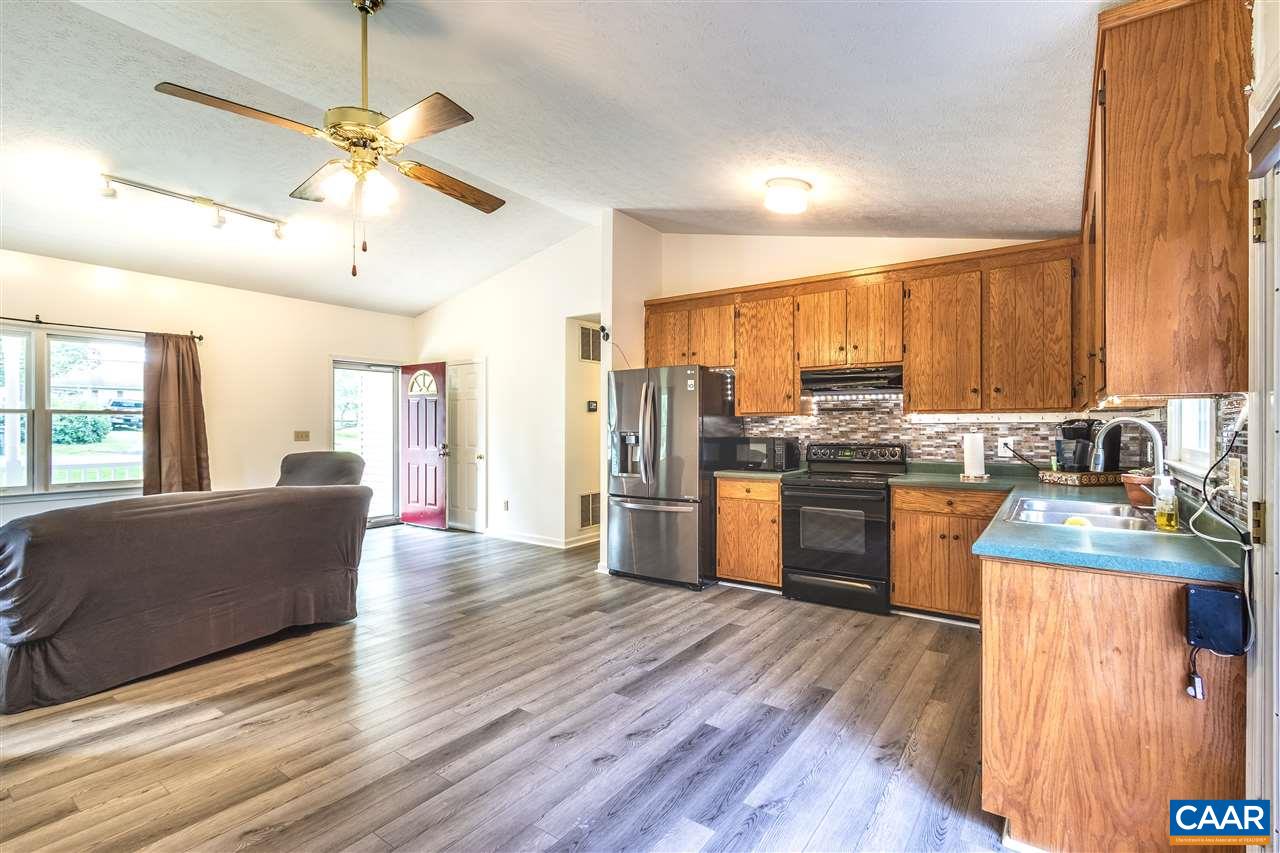 29 Narcissus Road Ruckersville, VA 22968 - Photo 8 of 26 a kitchen with stainless steel appliances kitchen island granite countertop a refrigerator a stove top oven a sink and dishwasher with wooden floor