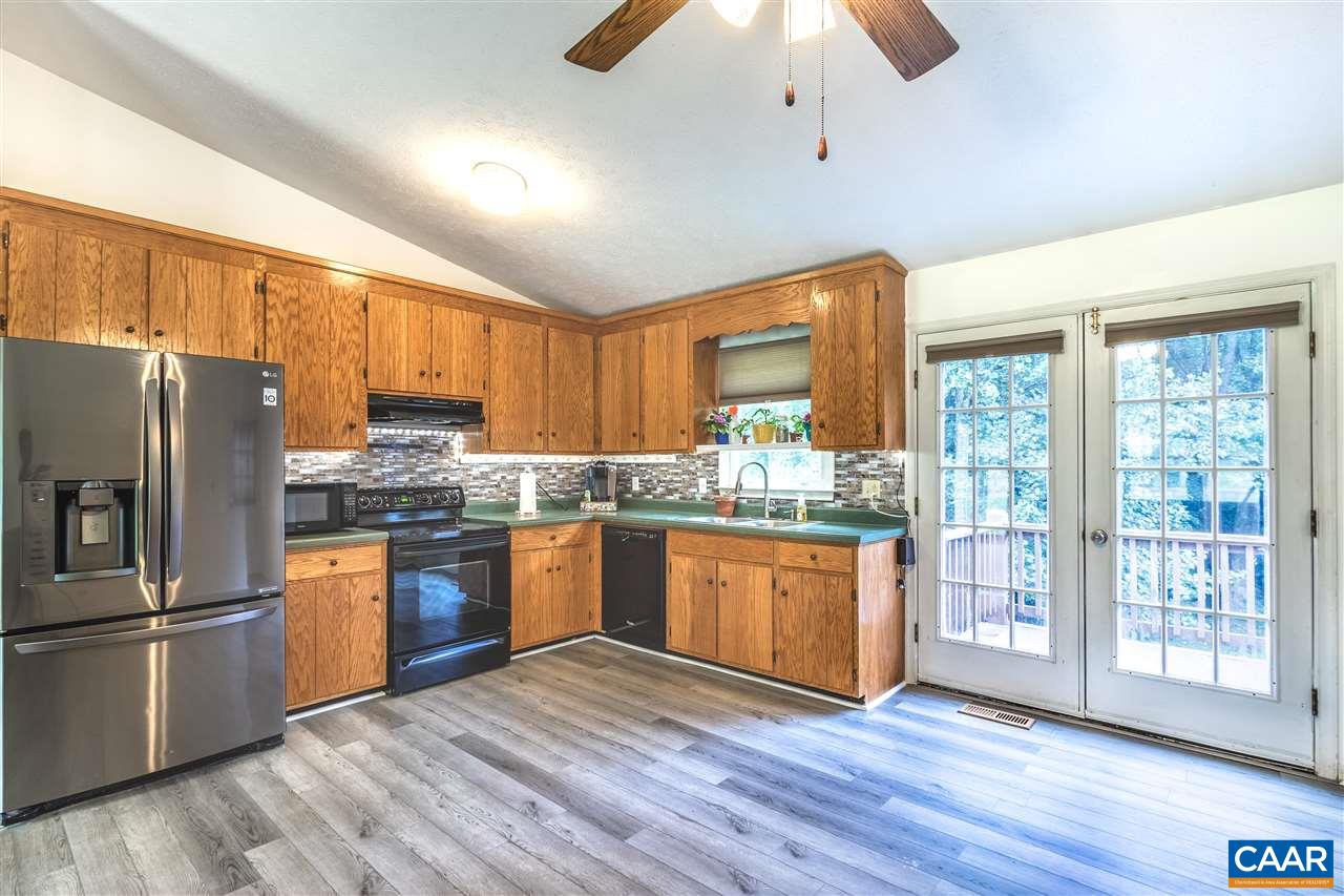 29 Narcissus Road Ruckersville, VA 22968 - Photo 9 of 26 a kitchen with granite countertop wooden floors stainless steel appliances and a counter space