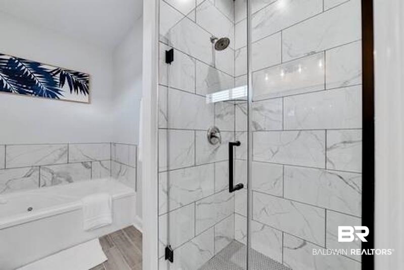 1492 Shell Lane Gulf Shores, AL 36542 - Photo 10 of 20 Full bath with a garden tub, a stall shower, and wood finished floors
