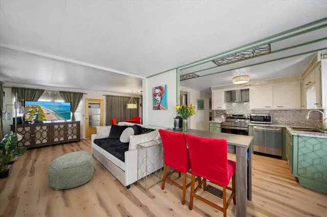 a living room with furniture a flat screen tv and a large window