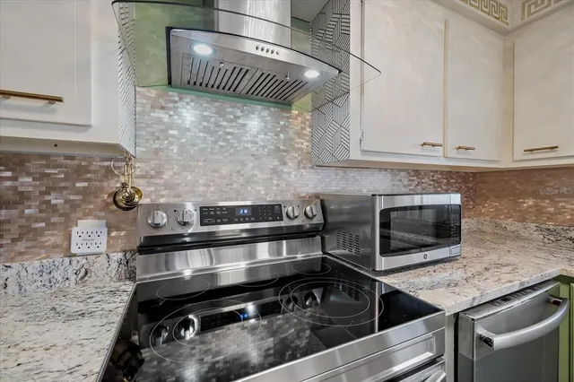 a kitchen with granite countertop a stove and a sink