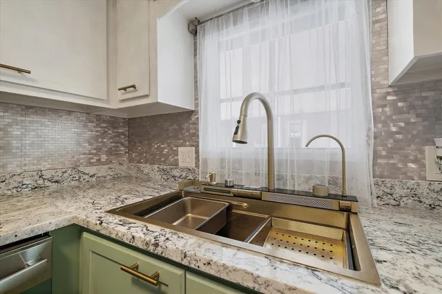 a close view of a sink a faucet and appliance in the kitchen