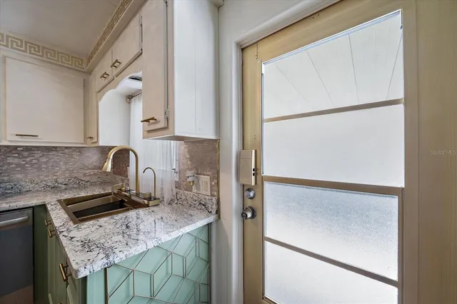 a kitchen with a refrigerator and a stove top oven