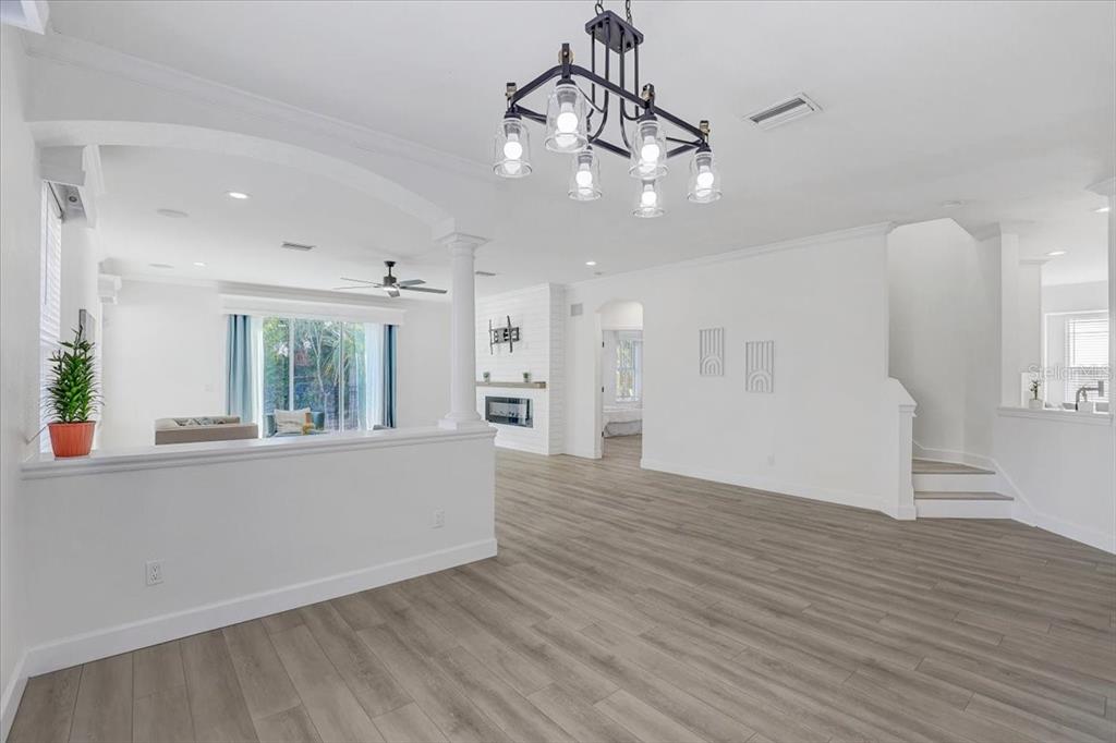 4006 91st Avenue East Parrish, FL 34219 - Photo 13 of 48 a view of an empty room and kitchen with wooden floor