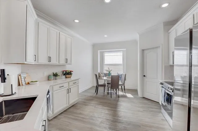 a kitchen with granite countertop a sink stove and cabinets