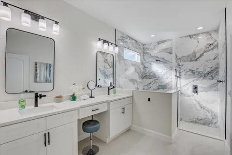 a bathroom with double sink and a mirror