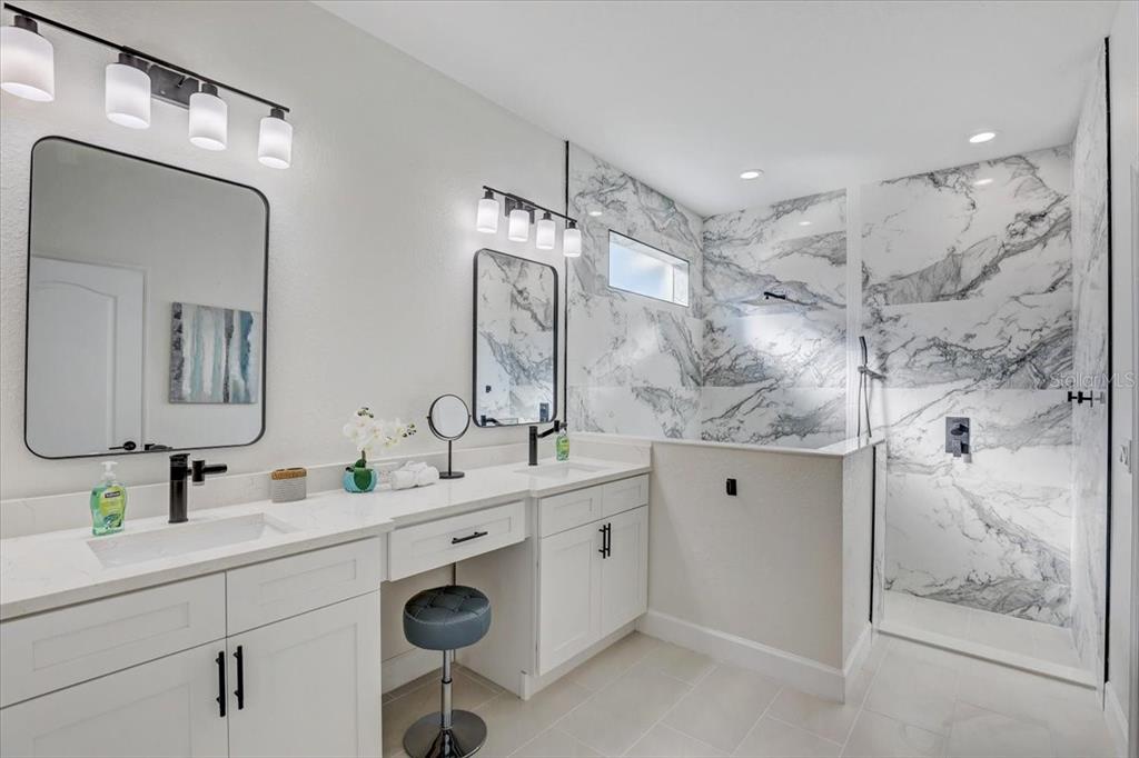 4006 91st Avenue East Parrish, FL 34219 - Photo 23 of 48 a bathroom with double sink and a mirror