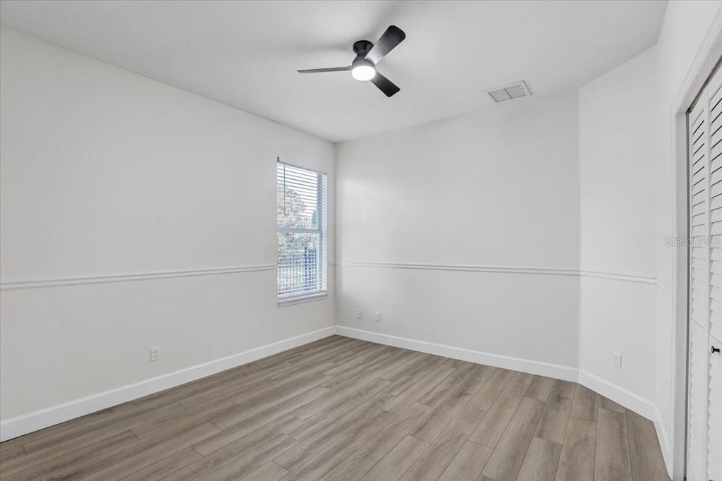 4006 91st Avenue East Parrish, FL 34219 - Photo 30 of 48 an empty room with wooden floor and windows