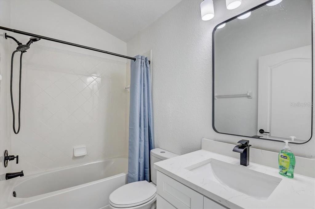 4006 91st Avenue East Parrish, FL 34219 - Photo 31 of 48 a bathroom with a sink toilet and shower