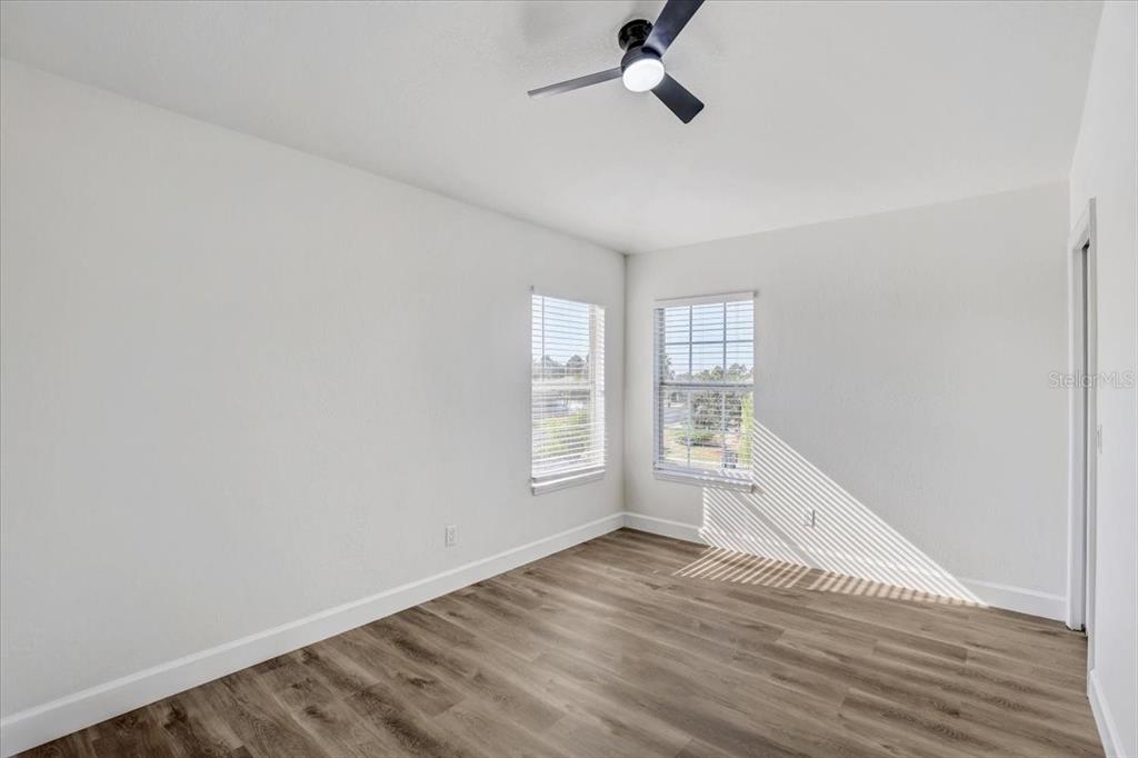 4006 91st Avenue East Parrish, FL 34219 - Photo 35 of 48 a view of empty room with wooden floor and fan