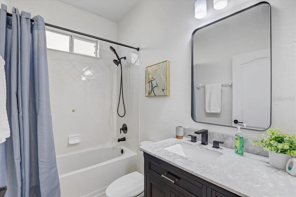4006 91st Avenue East Parrish, FL 34219 - Photo 36 of 48 a bathroom with a granite countertop bathtub shower sink vanity and toilet