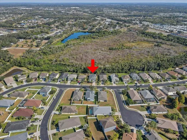 an aerial view of residential houses with outdoor space