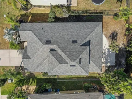 an aerial view of a house with a yard
