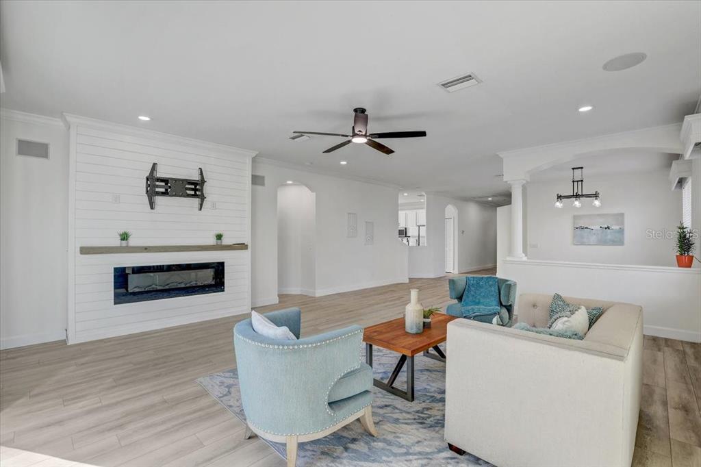 4006 91st Avenue East Parrish, FL 34219 - Photo 10 of 48 a living room with furniture and a fireplace