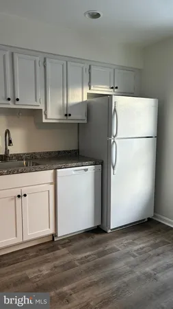 a white refrigerator freezer sitting in a kitchen