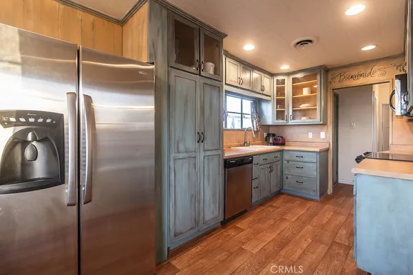 a kitchen with a refrigerator and a sink