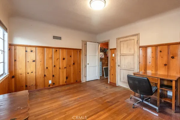 a view of a livingroom with workspace and a window