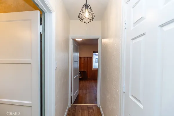 a view of a hallway with wooden floor