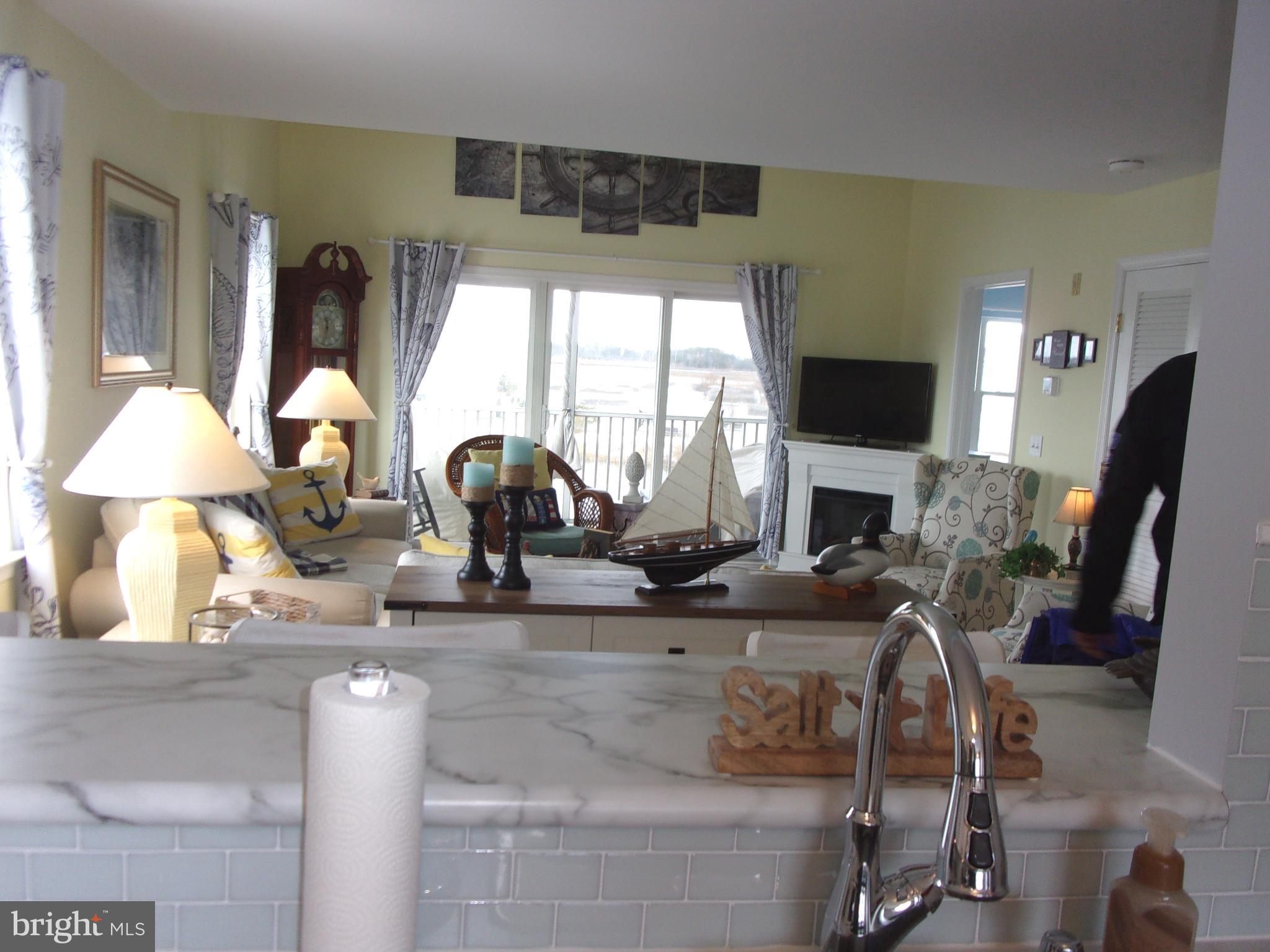 30397 Pavilion Drive, Unit 105 Ocean View, DE 19970 - Photo 11 of 34 Open concept through to screened porch