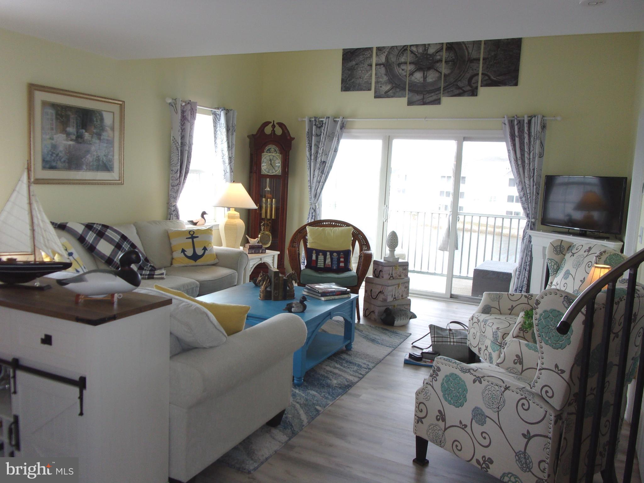 30397 Pavilion Drive, Unit 105 Ocean View, DE 19970 - Photo 13 of 34 Living room with access to screened porch