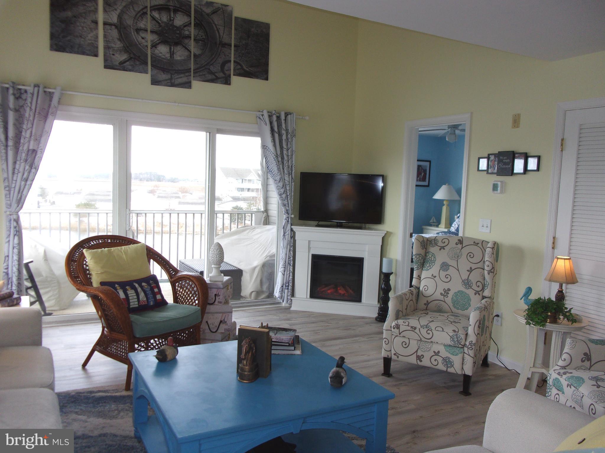 30397 Pavilion Drive, Unit 105 Ocean View, DE 19970 - Photo 15 of 34 Living room with electric fireplace