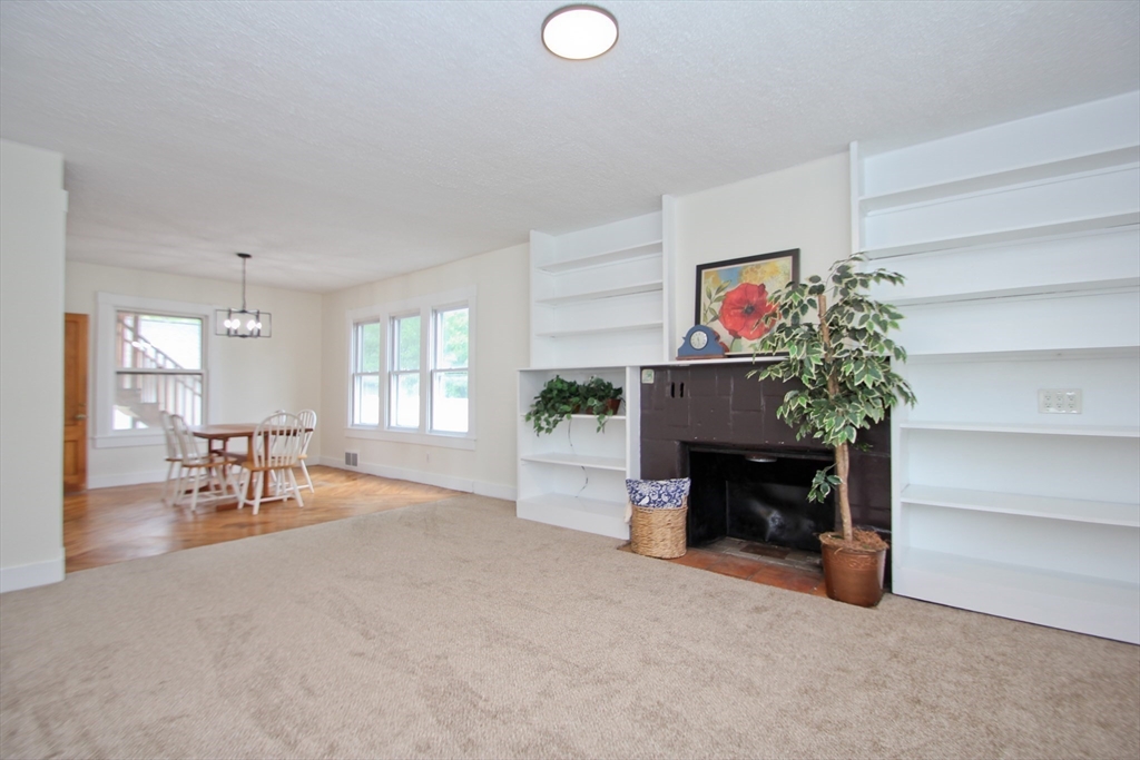 38 Virginia Street Springfield, MA 01108 - Photo 7 of 42 a living room with furniture and a fireplace