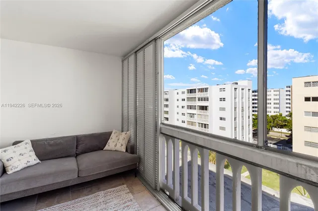 a view of a living room filled with furniture and a window