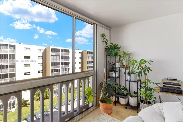 a living room filled with furniture and a potted plant