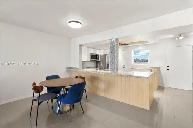 a kitchen with a table and chairs in it