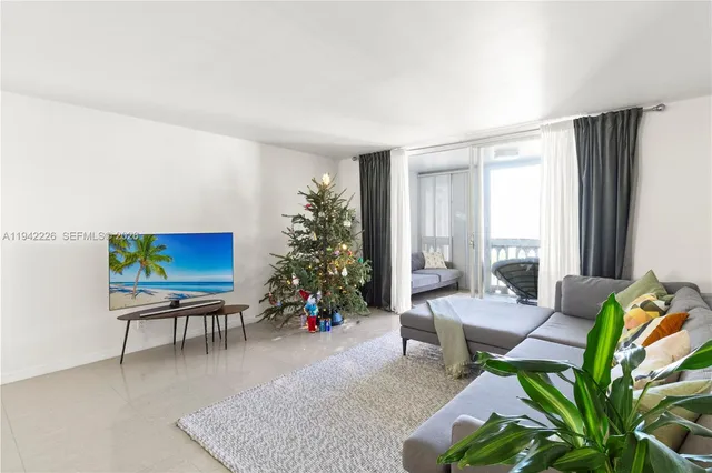 a living room with furniture potted plant and a window