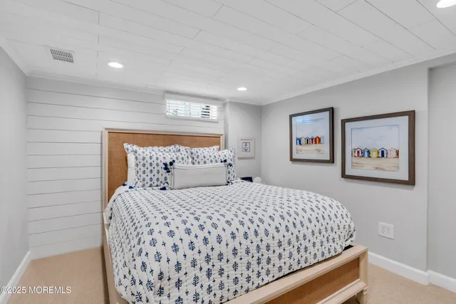 a bedroom with a bed and painting on the wall