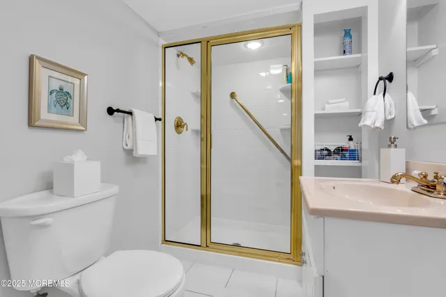 a bathroom with a sink a toilet and a shower