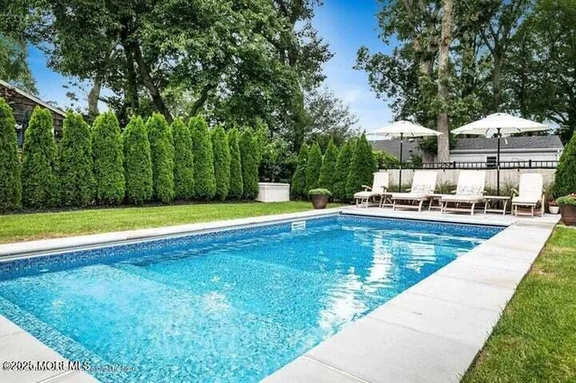 a view of a swimming pool with a yard