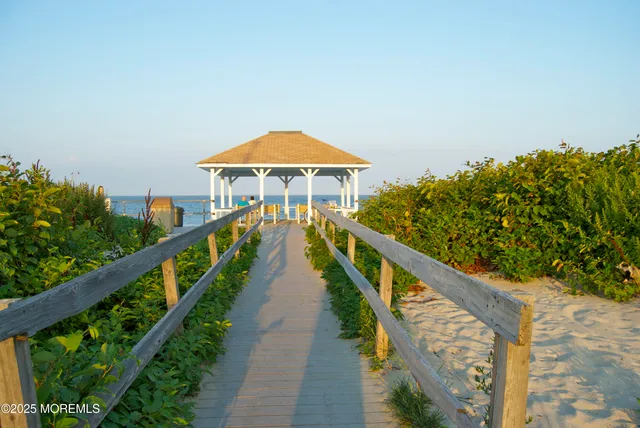 a view of a house with wooden floor next to a yard