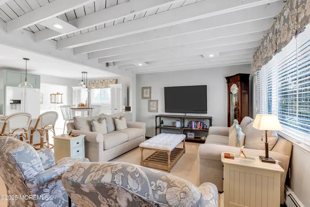 a living room with furniture wooden floor and a flat screen tv