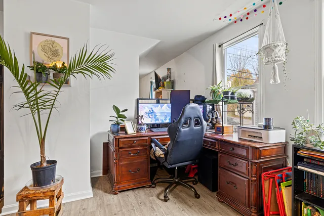 a view of a workspace with furniture and a potted plant