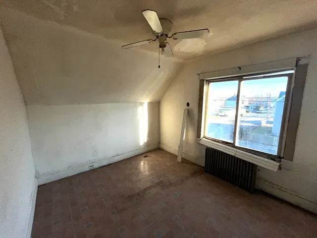 a view of a livingroom with wooden floor and a window