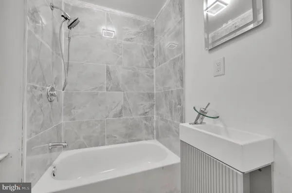 a bathroom with a bathtub and sink
