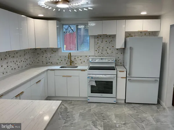 a kitchen with a sink and a refrigerator