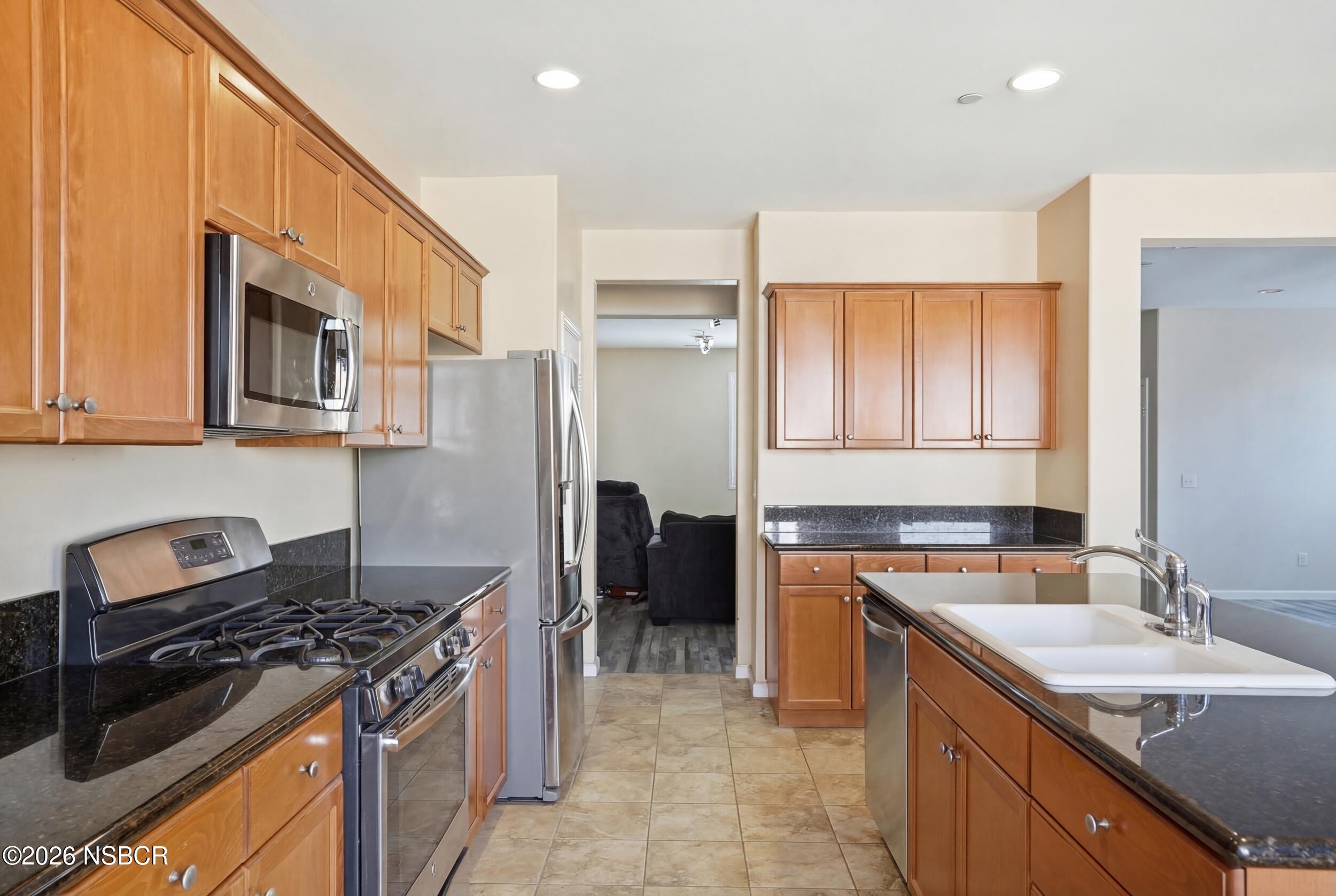 2205 Point Sal Loop Lompoc, CA 93436 - Photo 12 of 36 a kitchen with stainless steel appliances granite countertop a stove a sink and a refrigerator