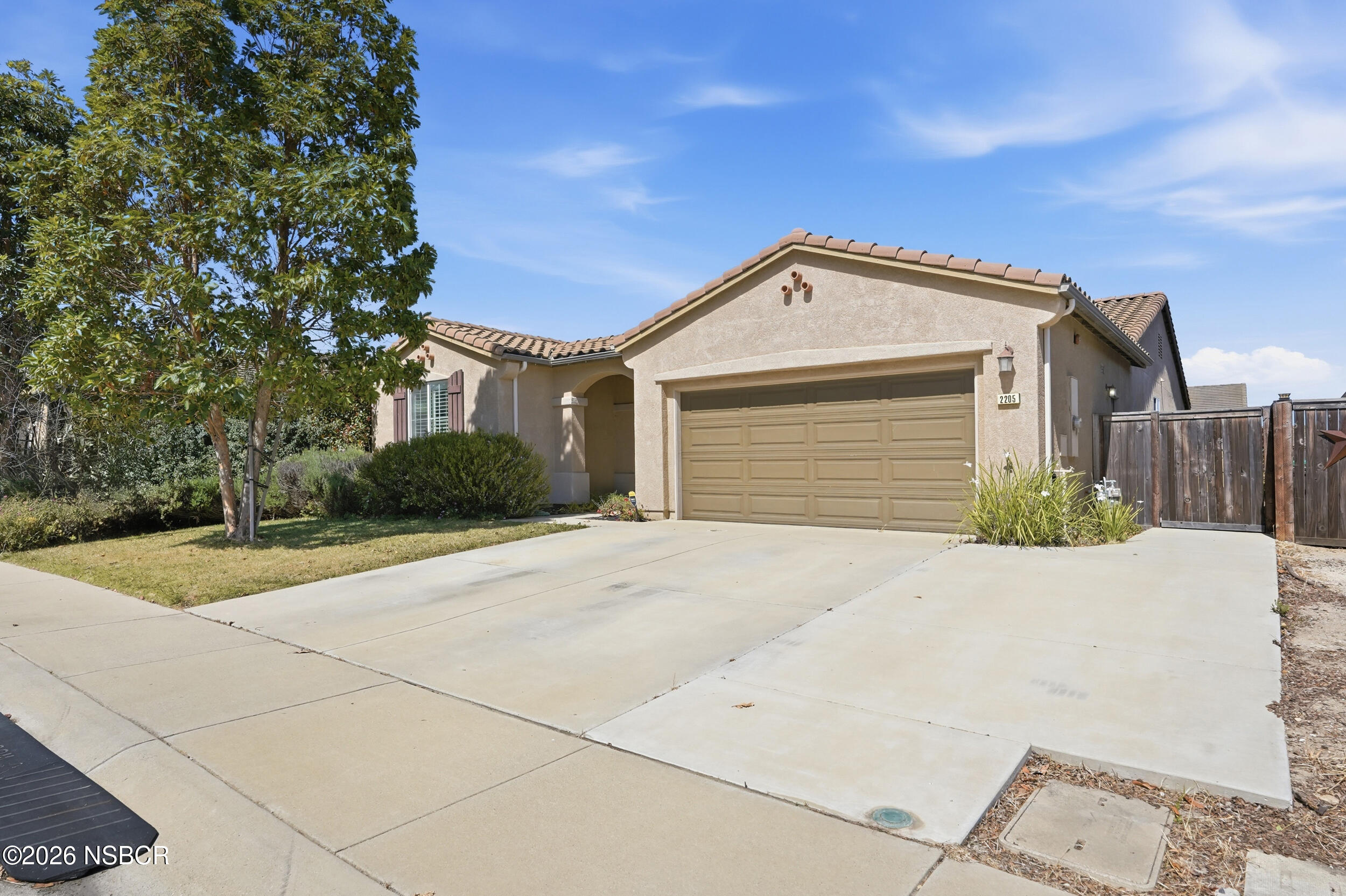 2205 Point Sal Loop Lompoc, CA 93436 - Photo 2 of 36 a front view of a house with a yard and garage