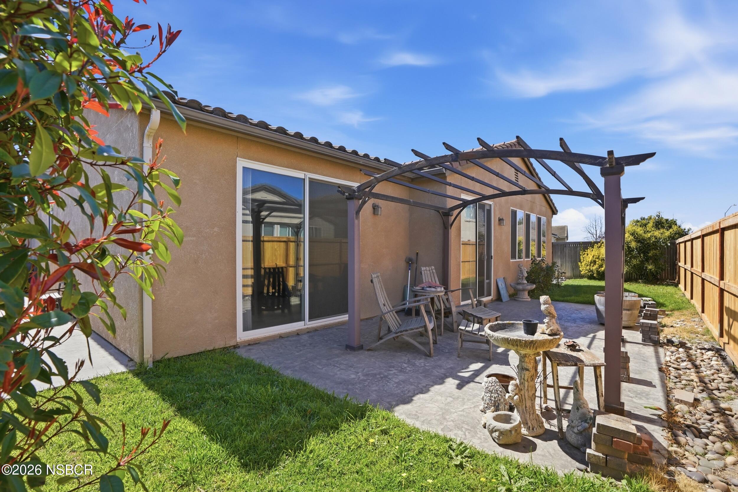 2205 Point Sal Loop Lompoc, CA 93436 - Photo 30 of 36 a view of a patio with table and chairs and potted plants