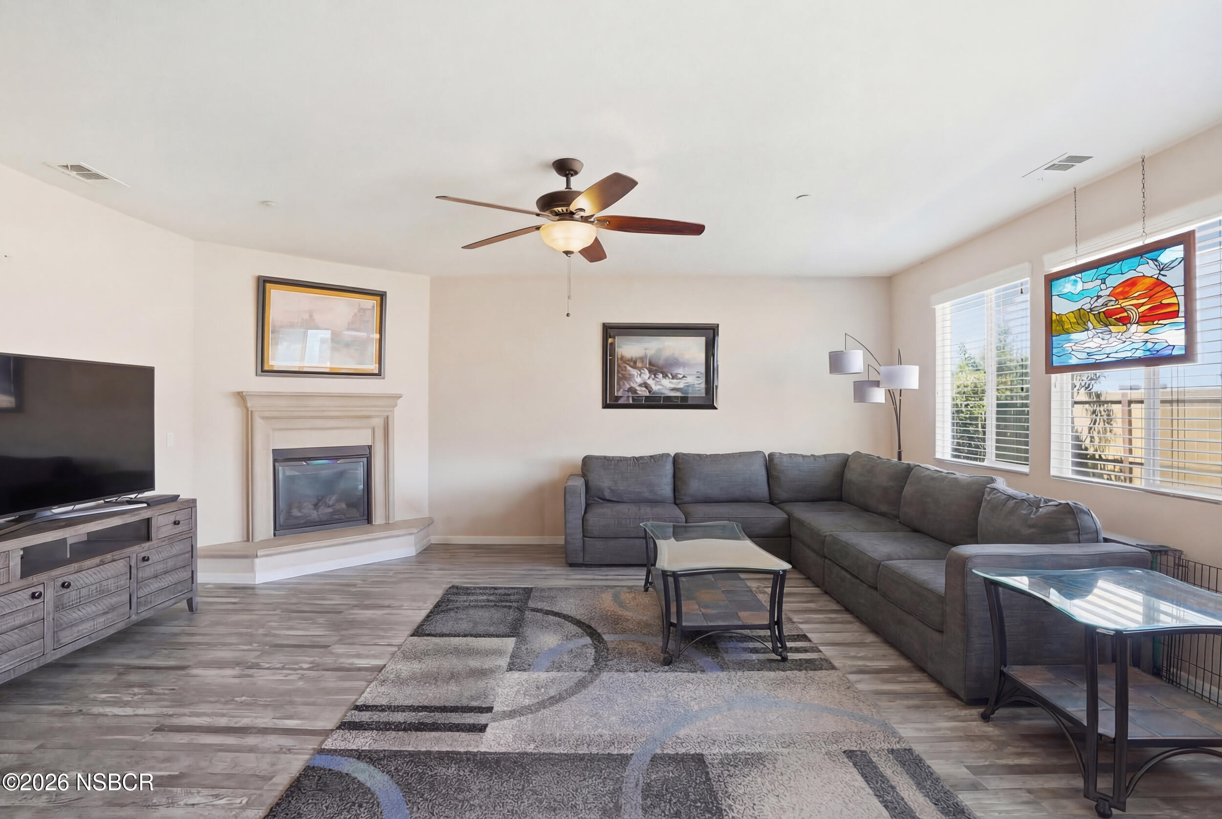 2205 Point Sal Loop Lompoc, CA 93436 - Photo 6 of 36 a living room with furniture a fireplace and a flat screen tv