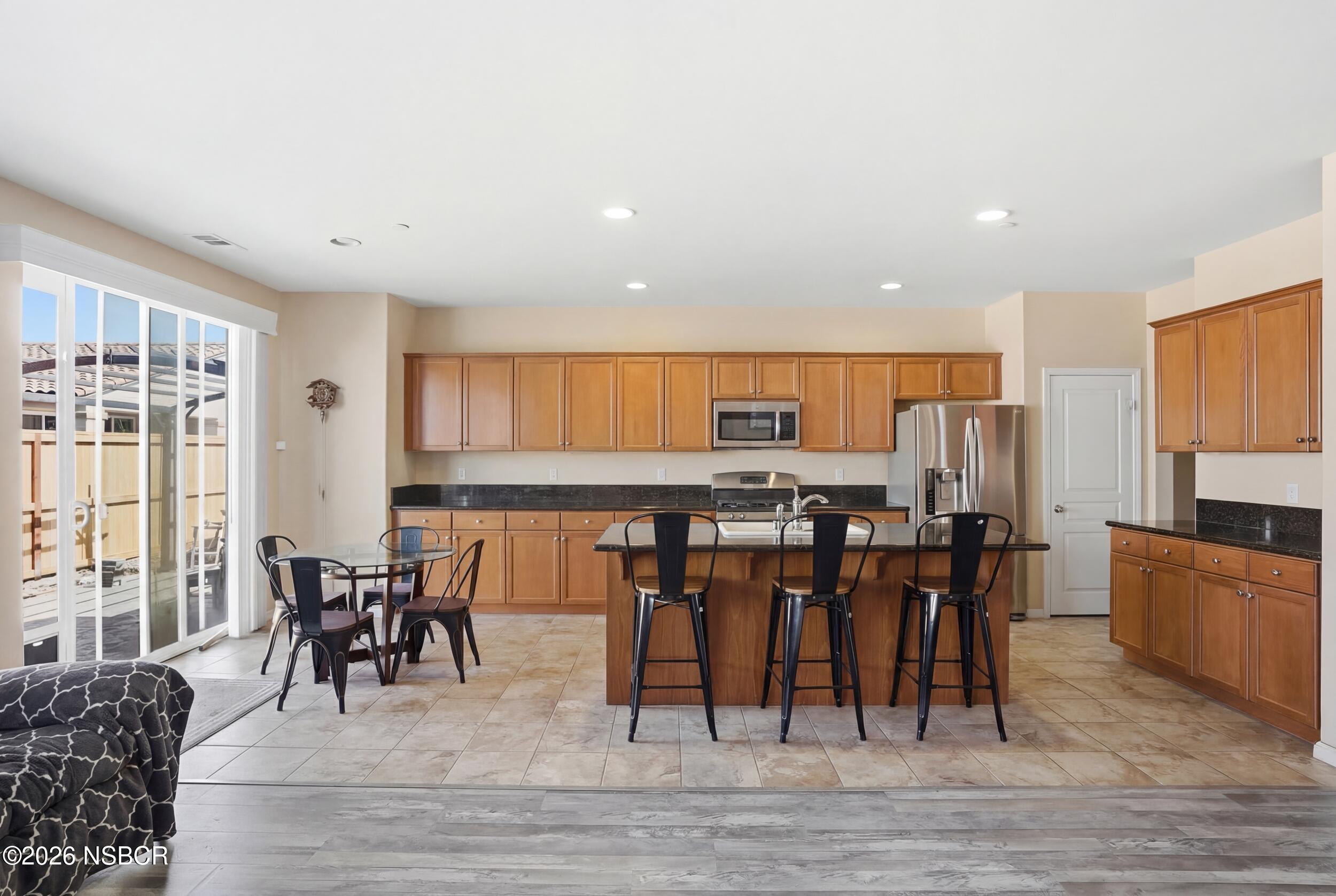 2205 Point Sal Loop Lompoc, CA 93436 - Photo 10 of 36 a dining room filled with furniture and wooden floor